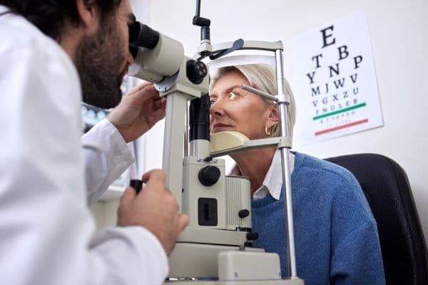 Eye exam slit lamp woman