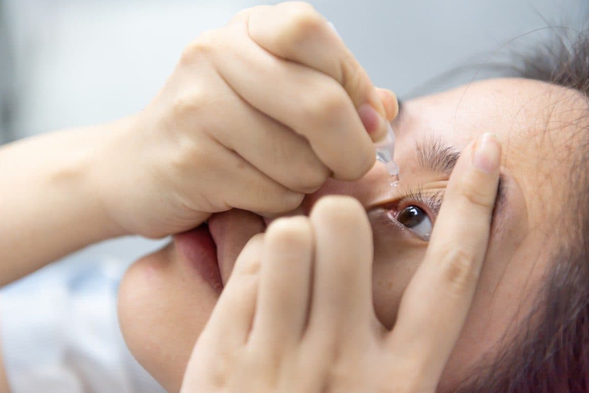 asian woman use eye drop