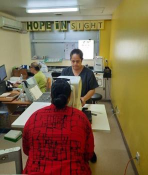 An ophthalmic nurse in Fiji performing refraction on a patient